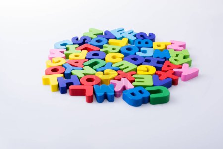 Photo for Colorful alphabet letter blocks scattered randomly on white background - Royalty Free Image