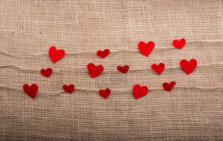 Concepto de amor con papeles en forma de corazón en hilos de lino