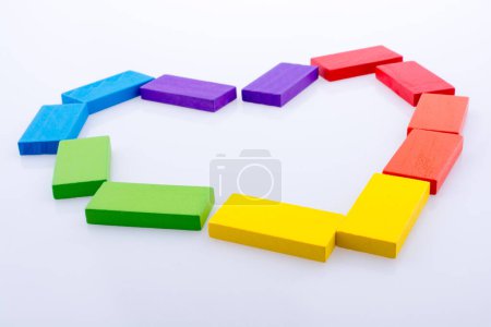 Photo for Colorful Domino Blocks forming a Heart on a white background - Royalty Free Image