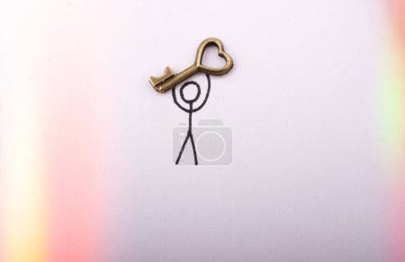 Photo for Man carrying a  heart shaped key  on white background - Royalty Free Image