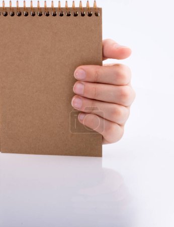 Foto de Cuaderno de mano de color marrón sobre fondo blanco - Imagen libre de derechos