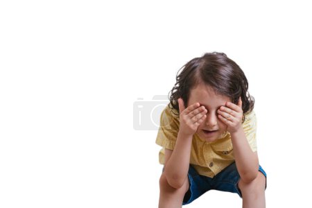 Photo for Boy cover his eyes with hand isolated on a white background. Cute happy child, positive face - Royalty Free Image