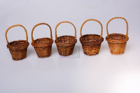 Photo for Little size Empty wicker baskets on  white background - Royalty Free Image
