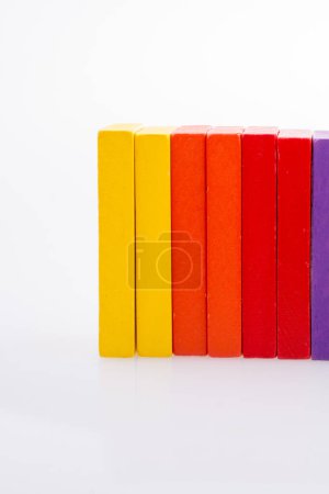 Photo for Hand holding color dominoes on a white background - Royalty Free Image