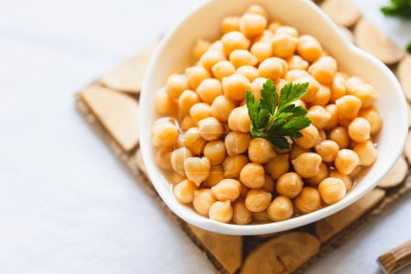 Photo for Cooked chickpeas in white bowl. Ingredient for Tasty vegetarian food. Boiled chickpeas, selective focus - Royalty Free Image