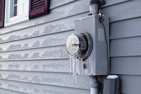 Téléchargez les photos : Compteur électrique congelé sur le parement extérieur de la maison
. - en image libre de droit