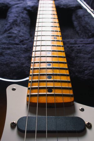 Photo for Closeup of an electric guitar's maple fretboard - Royalty Free Image