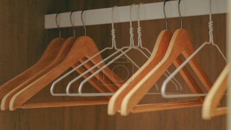 Photo for Several empty hangers hanging in the empty closet for organizing the closet, 3d rendering - Royalty Free Image