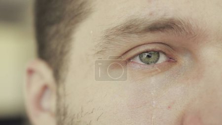Crying man with tears on face close up. Emotions, depression, problem concept. Slow motion