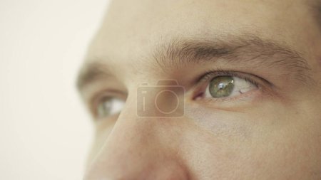 Vision and eye of man in studio isolated on white background. Cropped, close up. Eye care, vision concept. Slow motion