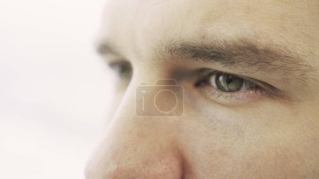 Caucasian male eyes. Isolated on white. Cropped, close up. Eye care, vision concept. Slow motion