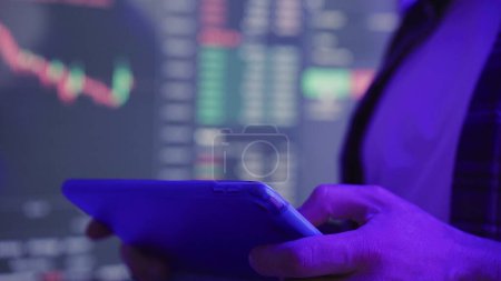 Crypto trader investor broker holding digital tablet, typing and analyzing financial chart trading. Slow motion. Investment risks and profit, technology concept