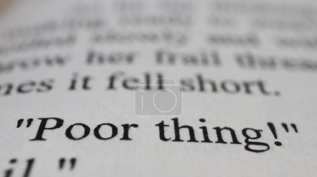 Photo for Poor thing text in open book page, selective focus, close up, macro shot of poor thing message, education idea and novel concept, sitting view - Royalty Free Image