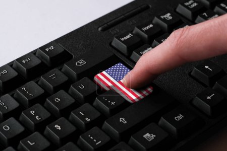 Photo for Pressing enter button with USA flag, represents a cyber-attack of United States, metaphor of learning American English language, black keyboard close up, front view, selective focus - Royalty Free Image