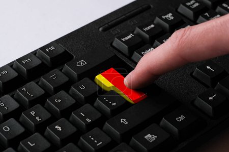 Photo for Pressing enter button with Germany flag, represents a cyber-attack of Germany, metaphor of learning German language, black keyboard close up, front view, selective focus, Deutschland - Royalty Free Image