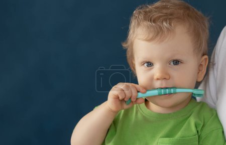 Photo for Cute baby 2 years old brushes his teeth with a toothbrush. The concept of oral hygiene and healthy teeth from infancy. - Royalty Free Image