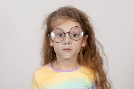 Photo for Portrait of a surprised little smart girl in glasses. Isolated on white background. - Royalty Free Image