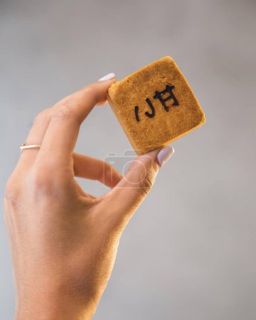 Téléchargez les photos : Asiatique nourriture dessert blanc fond, latino femme main tenant le cookie - en image libre de droit