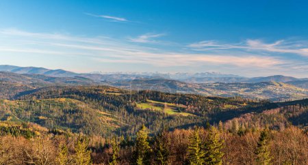 Photo for Nearer hills of Beskid mountains and Tatra mountains on the background from Cieslar hill in Beskid Slaski mountains on polish - czech borders during beautiful autumn day - Royalty Free Image