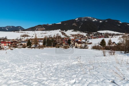Photo for Liptovska Luzna village with hills on the backgroud in Slovakia during beautiful winter day - Royalty Free Image