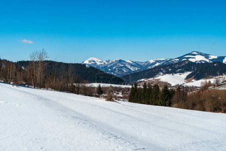 Photo for Velka Fatra mountains between Rakytov and Smrekovica hills from hiking trail above Liptovska Luzna village in Slovakia during winter day with clear sky - Royalty Free Image