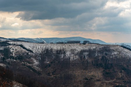 Photo for View to Radhost hill from Ondtejnik hill above Frydlant nad Ostravici town in Czech republic dueing early springtime day - Royalty Free Image