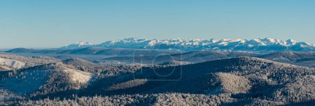 Nearer hills of Beskids mountains, part of Oravska Magura mountains and Tatra mountains from Velka Raca hill in winter Kysucke Beskydy mountains