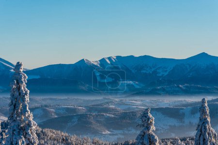 Photo for Poludnovy grun, Steny, Hromove, Chleb and Velky Krivan hills in Mala Fatra mountains from Velka Raca hill in Kysucke Beskydy mountain during amazing winter day - Royalty Free Image