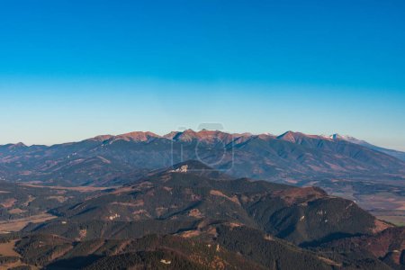 Tatra mountains from Velky Choc hill in Chocske vrchy mountains in Slovakia during late autumn day wirth clear sky