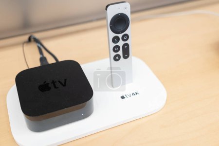 Téléchargez les photos : Product shot of the Apple TV 4k 2022 with WiFi and Ethernet, 128Gb RAM, and with Siri Remote, on store background. - en image libre de droit