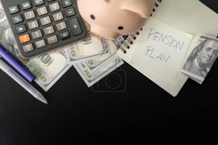 Photo for Paper note with text PENSION PLAN with stationery on desk. Pension Plan. Retirement concept. Pension calculation concept. copy space for text. Piggy bank. - Royalty Free Image