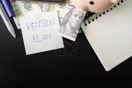 Photo for Paper note with text PENSION PLAN with stationery on desk. Pension Plan. Retirement concept. Pension calculation concept. copy space for text. Piggy bank. - Royalty Free Image