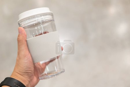 Photo for Hand holding Coffee Mug Silicone. coffee cup with silicone holder in  hand. Zero waste lifestyle. Copy Space. sustainability concept. - Royalty Free Image