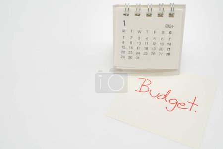 Photo for BUDGET text on paper with 2024 JAN calendar on a white background. Finance, money management concept. - Royalty Free Image