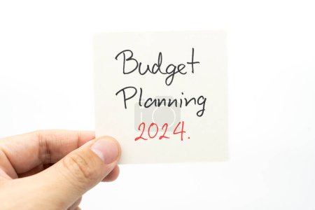 Budget Planning 2024 text message by hand writing on paper note. Budget planning concept.