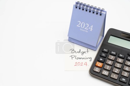 Budget Planning 2024 text message by hand writing on paper note, Calendar 2024 and Calculator. Budget planning concept. isolated on white background.