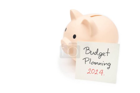 Budget Planning 2024 text message by hand writing on paper note and Piggy bank. Budget planning concept.