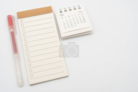 Blank Check list or Empty small notepad with checkbox and Simple desk calendar for OCTOBER 2024. Blank checklist for text. Copy Space.