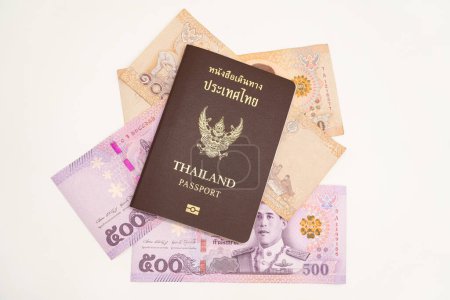 Thailändischer Pass und thailändisches Geld für Reisen mit isoliertem Hintergrund. Die Thailänder bereiteten sich auf ihren Urlaub in Japan vor. Reisefonds. Sparen für den Urlaub.