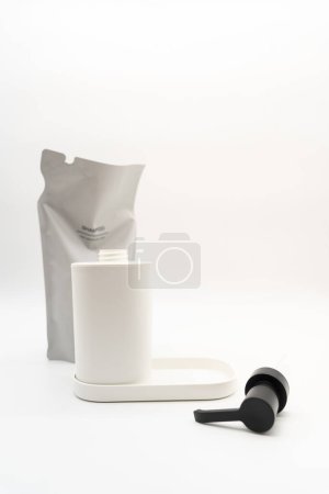 Plastic packaging for refill pouch and Plastic pump bottle in isolated background. Zero waste. Reuse reduce recycle concept. Refillable reusable personalised pump dispenser bottles.