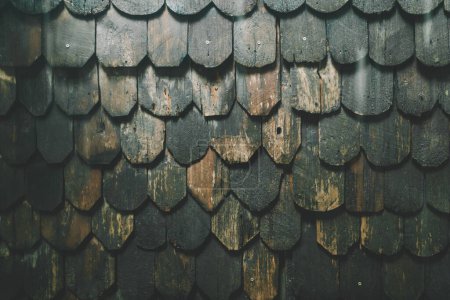 Old wooden roof tiles background. Old wooden shingles.