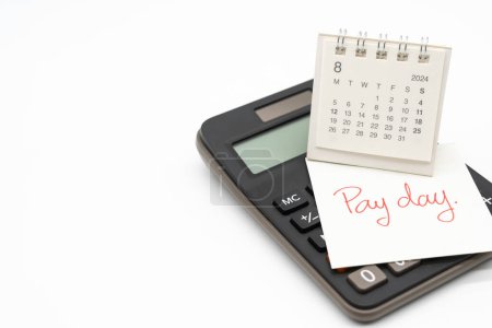 Hand writing text PAY DAY on August 2024 calendar with calculator in isolated background. Reminder concept of payment. copy space.