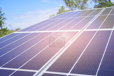 Photo for Tilt angle blue solar cell panel in garden with sunlight reflection. Solar cell technology, Power cell alternative source of electricity. Photovoltaic cell panel. Clean energy power concept - Royalty Free Image