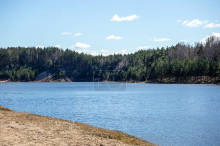 Nature view with blue lake water sky and sandy beach