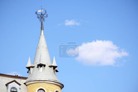 a building with several towers on a blue sky background
