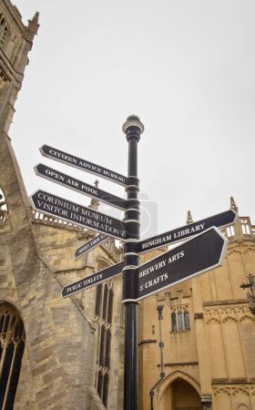 Photo for Signs with sights of the town of Cirencester in front of St John the Baptist Church - Royalty Free Image