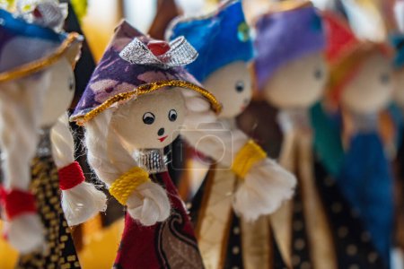 Photo for Details of the decoration of the end of the pencil With knick-knacks resembling dolls with various shapes and decorations, the wooden craft of rik-rok - Royalty Free Image