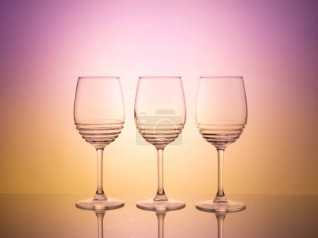 Colorful glassware photography with creative backlight and gel filters. Bright and vibrant image with abstract lighting effects. Ideal for graphic design and advertising projects.