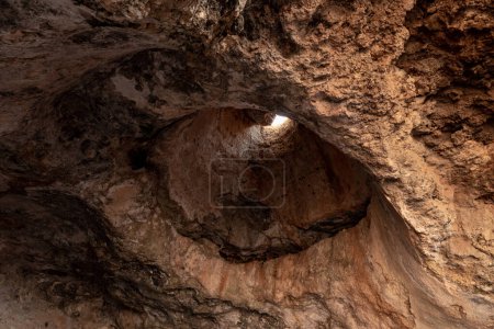 Photo for Hole for air and light in the ceiling of the cave where the primitive people lived in Tel Yodfat National park, in northern Israel - Royalty Free Image