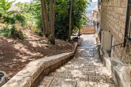 Photo for Stone steps leading down a quiet street in the old part of Safed city in northern Israel - Royalty Free Image